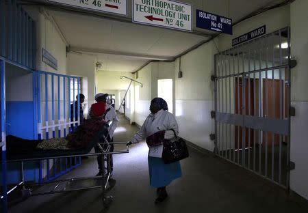 A patient is wheeled on a stretcher next to an isolation ward (R) set aside for Ebola related cases at the Kenyatta National Hospital (KNH) in the capital Nairobi August 19, 2014. REUTERS/Noor Khamis