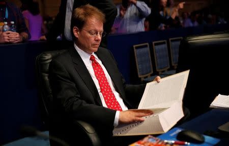 Dr. Jacques Bailly, the event pronouncer for the 89th annual Scripps National Spelling Bee, reads from a dictionary during a break at National Harbor in Maryland, U.S., May 25, 2016. REUTERS/Kevin Lamarque