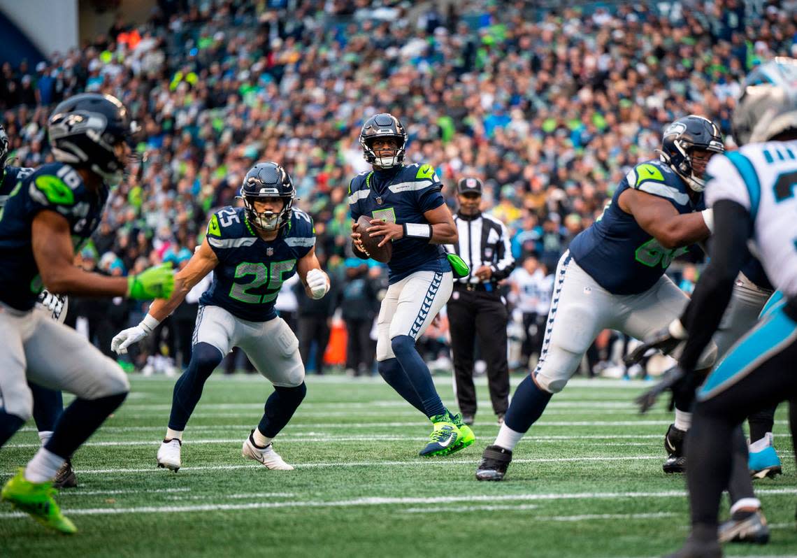 Seattle Seahawks quarterback Geno Smith (7) looks to pass the ball in the second quarter of an NFL game against the Carolina Panthers at Lumen Field in Seattle Wash., on Dec. 11, 2022. The Seahawks lost to the Panthers 24-30.