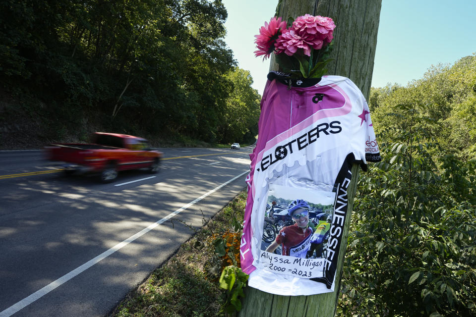 A roadside memorial for cyclist Alyssa Milligan is seen along state Highway 100 near Percy Warner Park, Friday, Sept. 15, 2023, in Nashville, Tenn. Milligan was struck and killed by a pickup truck near the site while riding with a friend the previous week. (AP Photo/George Walker IV)