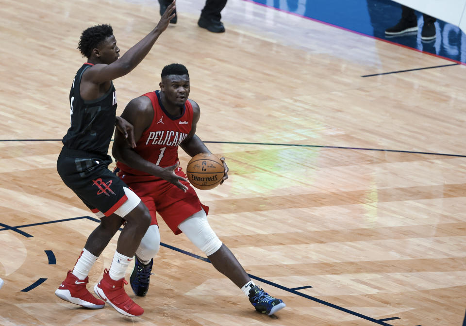 New Orleans Pelicans forward Zion Williamson (1) drives past Houston Rockets forward Jae'Sean Tate (8) in the third quarter of an NBA basketball game in New Orleans, Saturday, Jan. 30, 2021. (AP Photo/Derick Hingle)