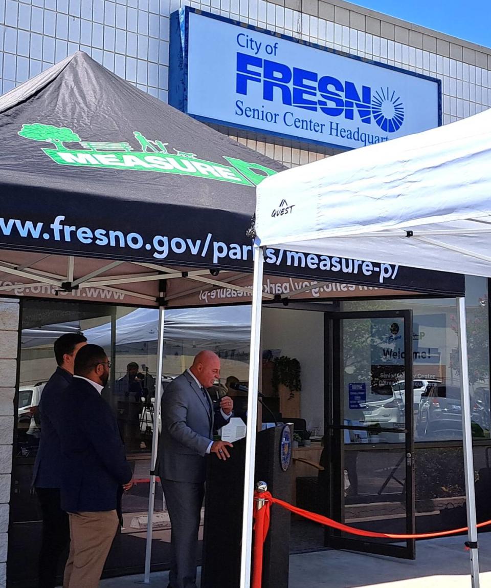 Fresno Mayor Jerry Dyer, center, speaks at a July 5, 2023, ribbon-cutting for a newly opened planning headquarters for a senior activities center in central Fresno. He was joined by Fresno City Council members Tyler Maxwell, partially obscured at left, and Nelson Esparza, left.
