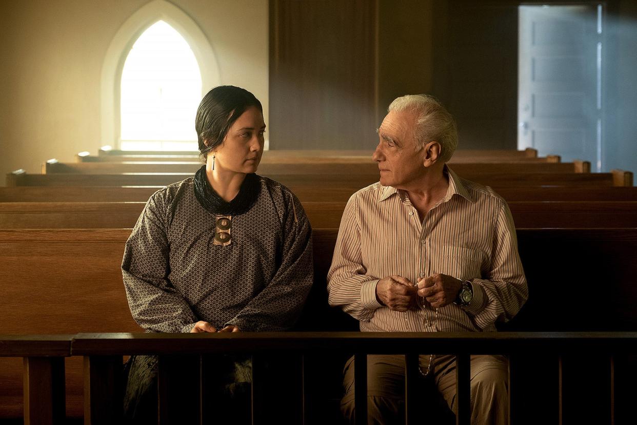 An Osage woman, played by Lily Gladstone, sits in a church pew beside an older white man, played by Martin Scorsese.