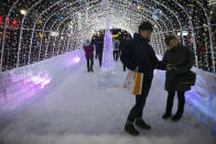 Tourists take a selfie in a tunnel made with ice blocks at the annual Sapporo Snow Festival, Feb. 4, 2020, in Sapporo, Hokkaido, Japan. (AP Photo/Jae C. Hong)