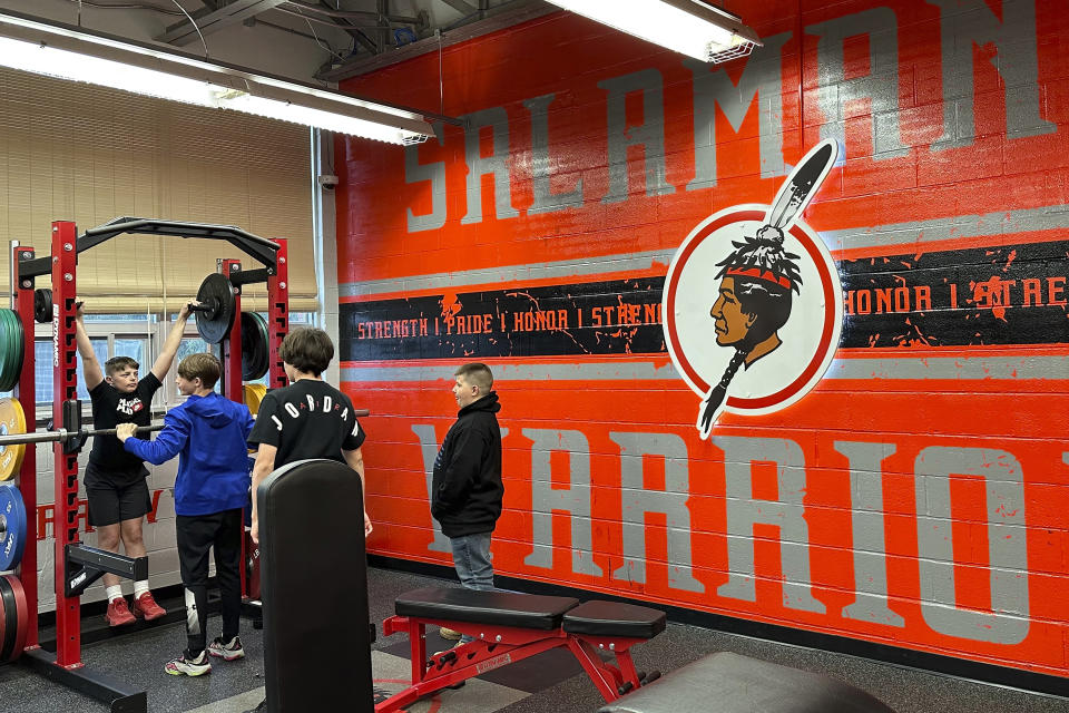 The logo of the Salamanca City Central School District is featured in the weight room at Salamanca High School in Salamanca, N.Y., on April 18, 2023. The school district, located on Seneca Nation of Indians territory, may have to replace its logo after New York passed a ban on the use of Indigenous names, mascots and logos by public schools. (AP Photo/Carolyn Thompson)