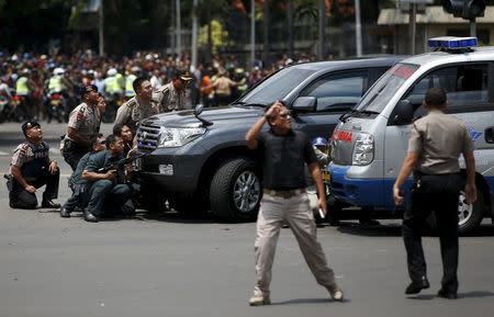 Police officers react near the site of a blast in Jakarta, Indonesia, January 14, 2016. REUTERS/Darren Whiteside