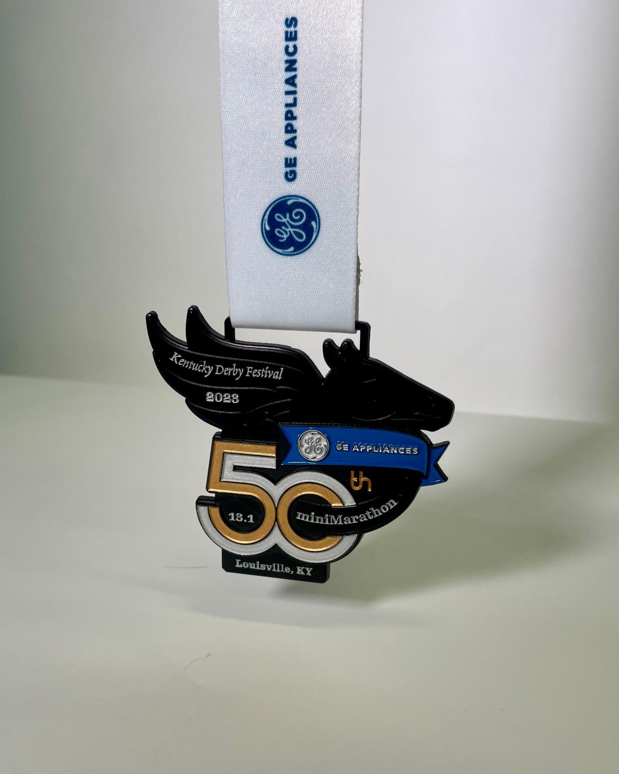 The commemorative 50th anniversary finishers medal for 2023 GE Appliances KDF 31.1 mile miniMarathon