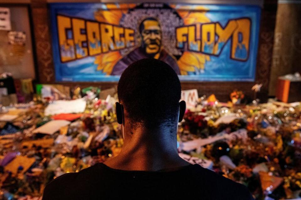 A man recites spoken word poetry at a memorial honoring George Floyd, at the spot where he was taken into custody, in Minneapolis.