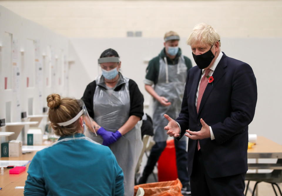 LEICESTER, ENGLAND - NOVEMBER 06: British Prime Minister Boris Johnson speaks to staff at a testing centre in De Montfort University, amid the outbreak of the coronavirus disease (COVID-19) on November 6, 2020 in Leicester, United Kingdom. (Photo by Molly Darlington - WPA Pool/Getty Images)