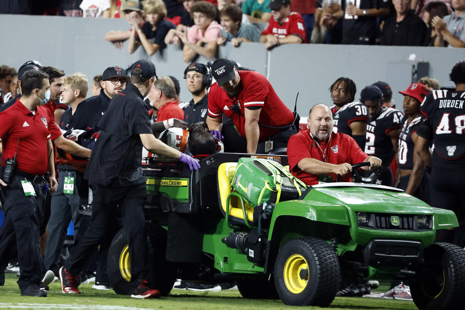 Texas Tech's Bryce Ramirez (54) is carted off the field by medical staff following suffering an unknown injury to his left leg during the first half of an NCAA college football game against North Carolina State in Raleigh, N.C., Saturday, Sept. 17, 2022. (AP Photo/Karl B DeBlaker)
