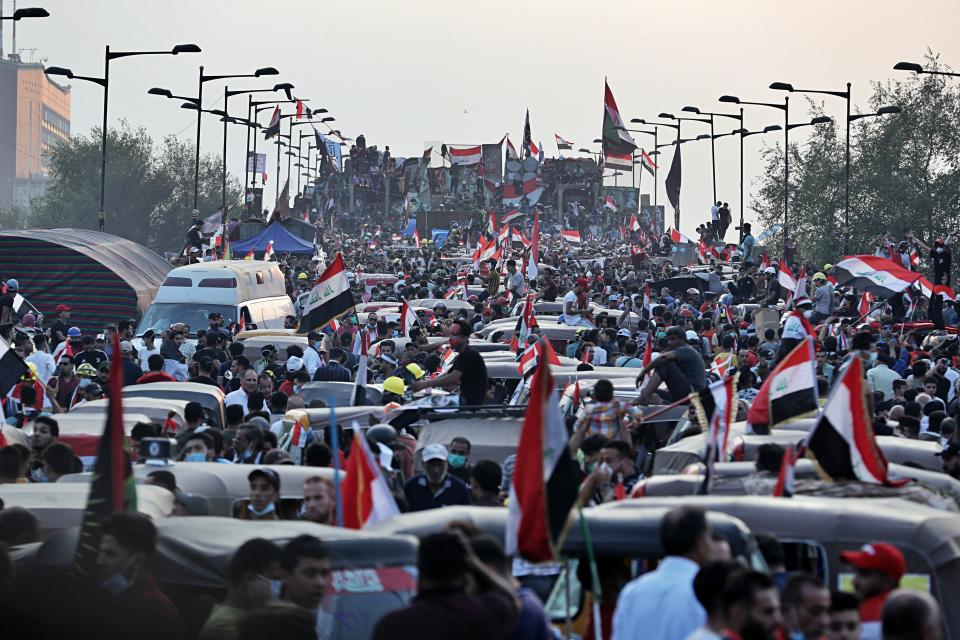 Anti-government protesters gather on the Joumhouriya closed bridge leading to the Green Zone government areas during ongoing protests in Baghdad, Iraq, Sunday, Nov. 3, 2019. (AP Photo/Khalid Mohammed)