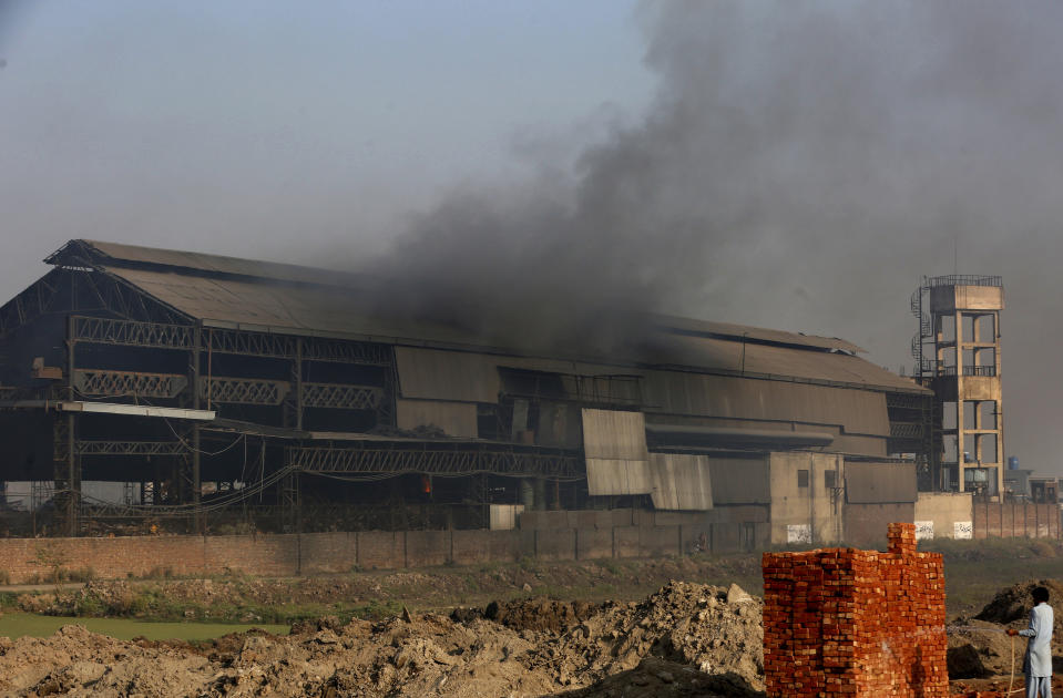 Smoke is rizes from a steel factory in Lahore, Pakistan, Monday, Nov. 22, 2021. People of Lahore and adjacent area are suffering from respiratory problems because of poor air quality related to thick smog hanging over the region. (AP Photo/K.M. Chaudary)