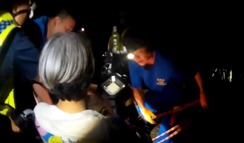 救難人員將身體不適、受困的婦人，用輪椅推送穿越竹林緊急送醫。(圖／翻攝畫面)
