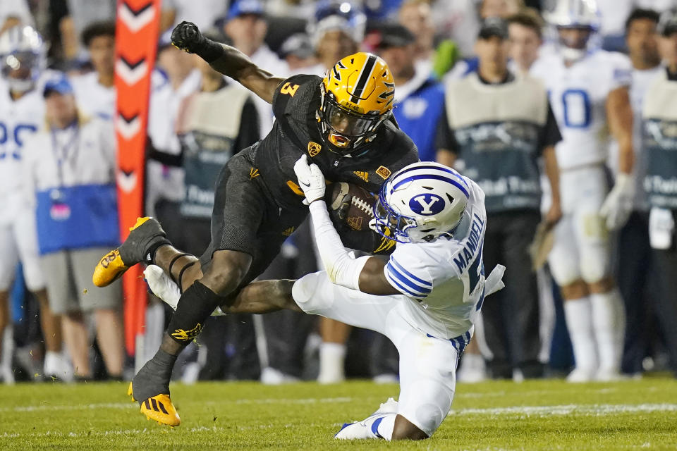 BYU defensive back D'Angelo Mandell (5) tackles Arizona State running back Rachaad White (3) in the second half during an NCAA college football game Saturday, Sept. 18, 2021, in Provo, Utah. (AP Photo/Rick Bowmer)