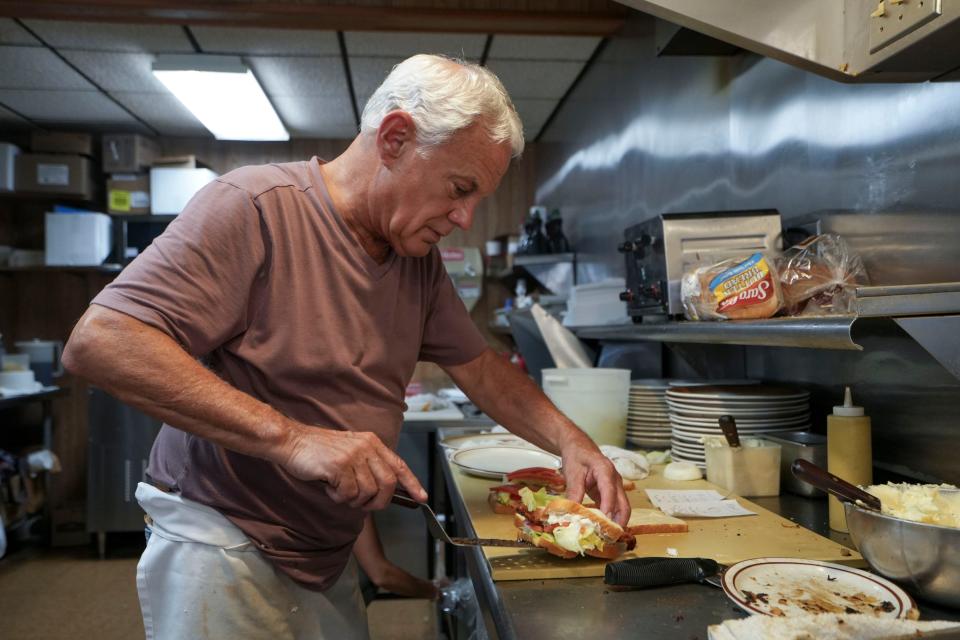 Jerry DiManno makes sandwiches during the lunch rush at his restaurant, Poopie’s in Glens Falls, New York. DiManno supports Congresswomen Elise Stefanik and hangs her photo on his wall at his restaurant.