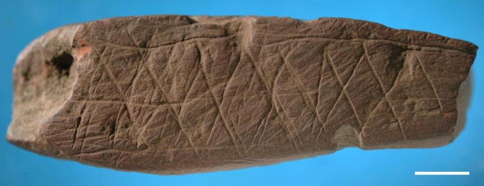 An abstract pattern appears to have been engraved on this piece of ochre, which was also found at Blombos Cave in the same archaeological debris that yielded the silcrete flake (Errico/Henshilwood/Nature)