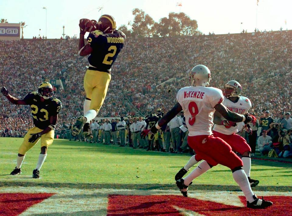 Michigan's cornerback Charles Woodson leaps to make an interception in the 1998 Rose Bowl.