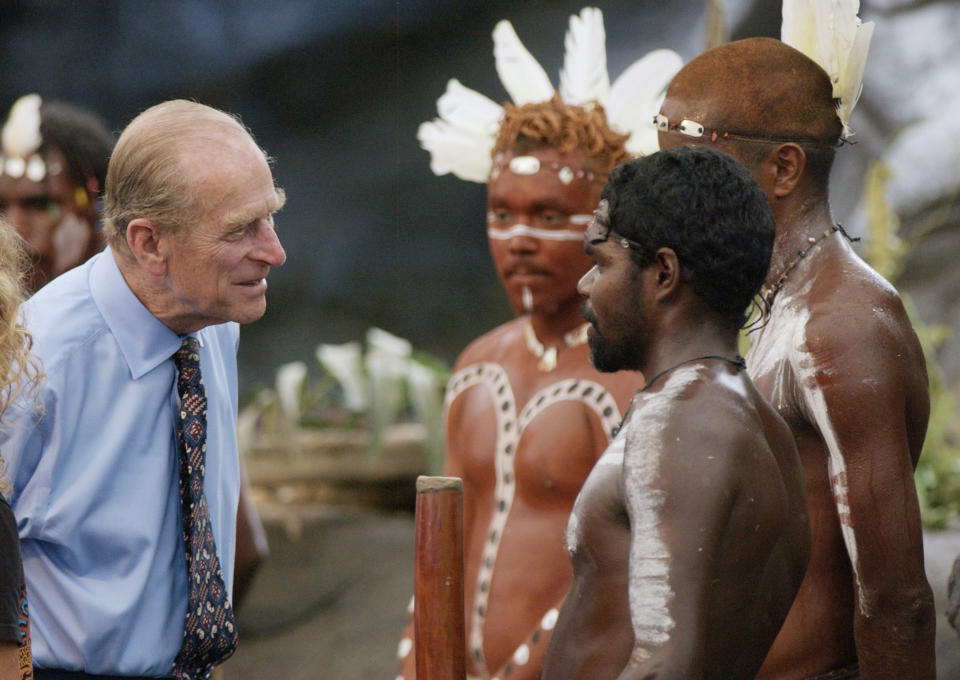 The Duke of Edinburgh talks to Aboriginal performers after watching a culture show at Tjapukai Aboriginal Culture Park, Cairns, Queensland, Australia. The Duke surprised the aborigines when he asked them 