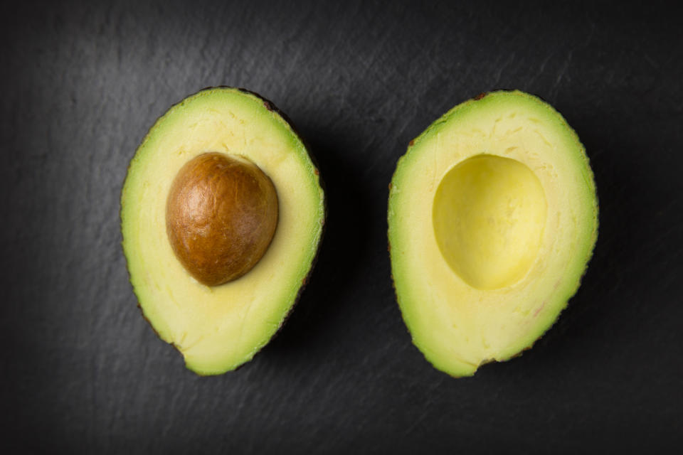 Brushing melted coconut oil over the open half of your avocado will help to form a protective layer that makes it take longer to brown. Photo: Getty