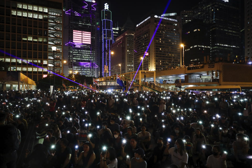 Protesters fresh their smartphone's lights to support the prayer rally at Edinburgh Place in Hong Kong, Saturday, Oct. 19, 2019. Hong Kong pro-democracy protesters are set for another weekend of civil disobedience as they prepare to hold an unauthorized protest march to press their demands. (AP Photo/Mark Schiefelbein)