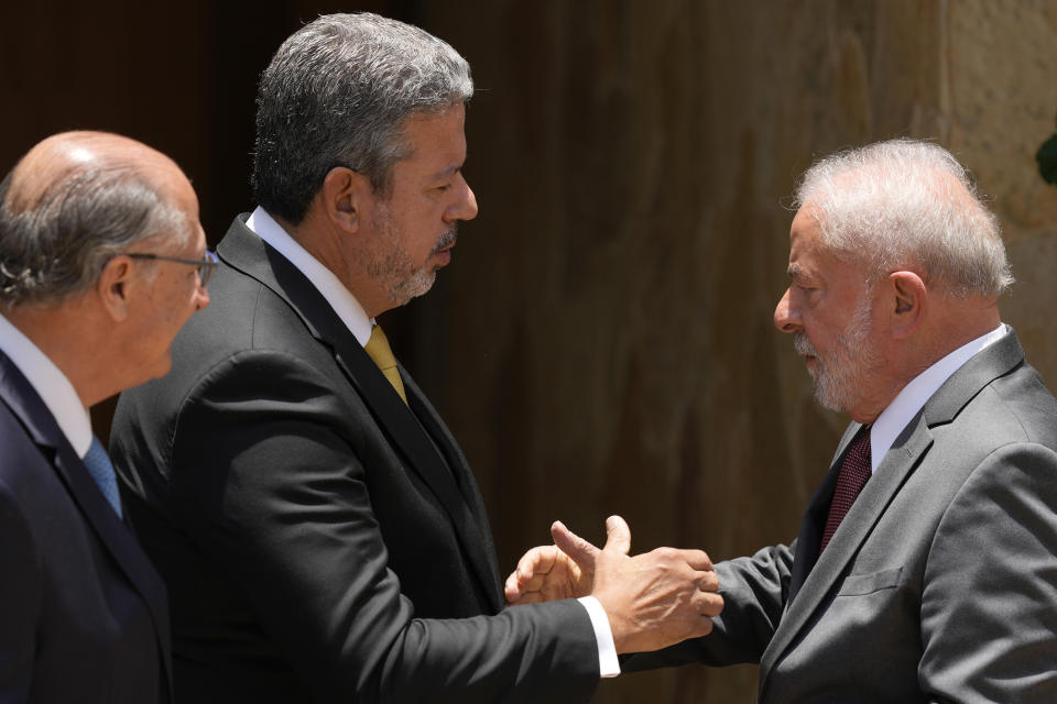 Brazilian President-elect Luiz Inacio Lula da Silva, right, shakes hands with Chamber of Deputies President Arthur Lira, next to his Vice President-elect Geraldo Alckmin, after a meeting in Brasilia, Brazil, Wednesday, Nov. 9, 2022. On his first day in Brazil's capital after winning the election, Da Silva is meeting with the leaders of each house of Congress ahead of his inauguration on Jan. 1. (AP Photo/Eraldo Peres)
