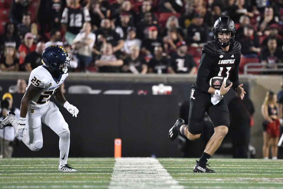 Louisville quarterback Jack Plummer (13) is pursued by Murray State defensive back Caldra Williford (25) during the second half of an NCAA college football game in Louisville, Ky., Thursday, Sept. 7, 2023. (AP Photo/Timothy D. Easley)