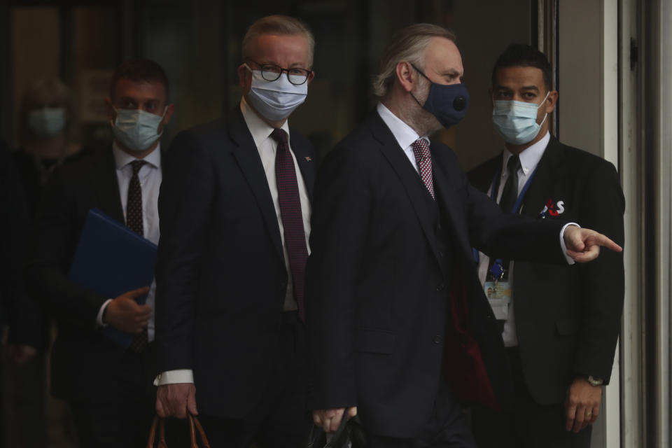 Chancellor of the Duchy of Lancaster Michael Gove, center left, leaves the third meeting of the EU-UK Joint Committee at EU headquarters in Brussels, Monday, Sept. 28, 2020. Chancellor of the Duchy of Lancaster Michael Gove on Monday met with Vice-President of the European Commission in charge of Inter-institutional relations and Foresight Maros Sefcovic, while EU chief Brexit negotiator Michel Barnier joined by videoconference. (AP Photo/Francisco Seco)