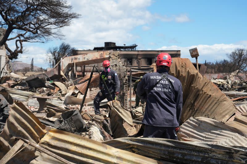 FILE PHOTO: Members of FEMA Urban Search and Rescue teams comb through destroyed Lahaina neighborhoods