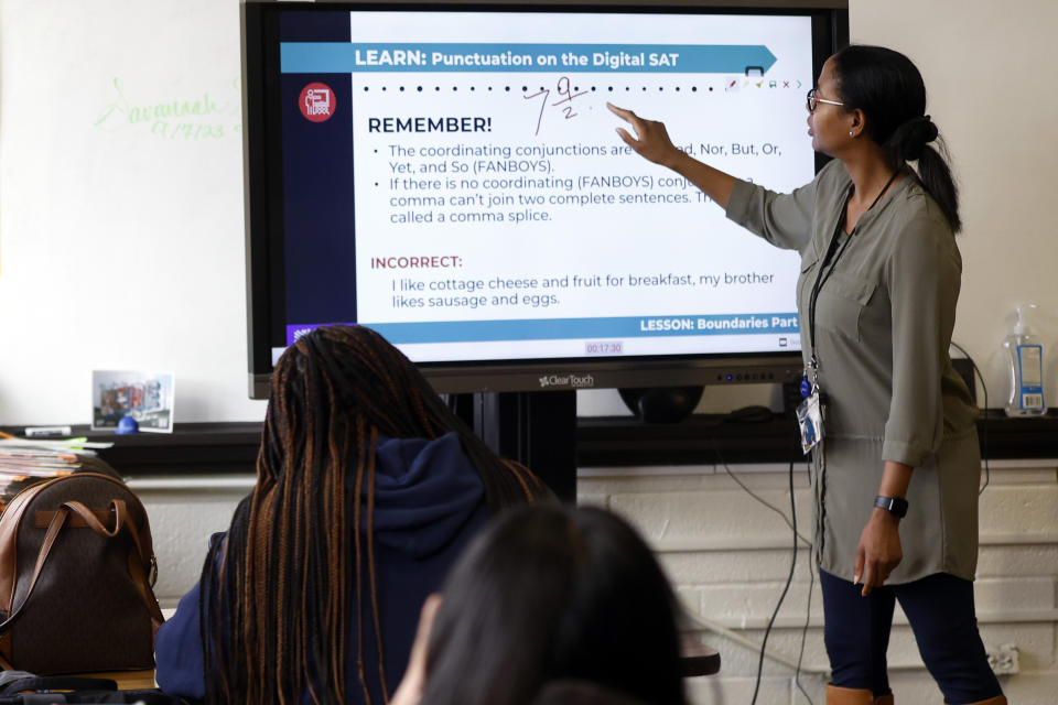 S'Heelia Marks gives instruction to students to prepare them for the digital SAT, Wednesday, March 6, 2024, at Holy Family Cristo Rey Catholic High School in Birmingham, Ala. (AP Photo/Butch Dill)