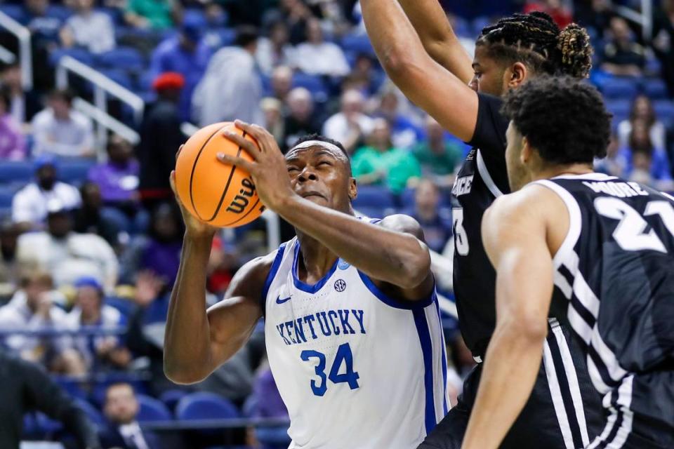 Kentucky forward Oscar Tshiebwe (34) drives to the basket against Providence forward Bryce Hopkins (23) during an NCAA Tournament first-round game at Greensboro Coliseum in Greensboro, N.C., on Friday.