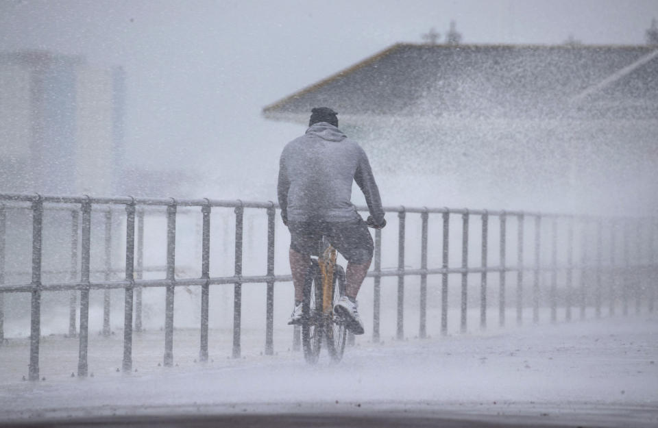 <p>A cyclist is hit by sea spray as they cycle along Clarence Esplanade in Southsea, Portsmouth, England, Wednesday March 10, 2021. Safety warnings have been issued for coastal areas of England and Wales as winds of up to 70mph are forecast for Wednesday evening. (Andrew Matthews/PA  via AP)</p>
