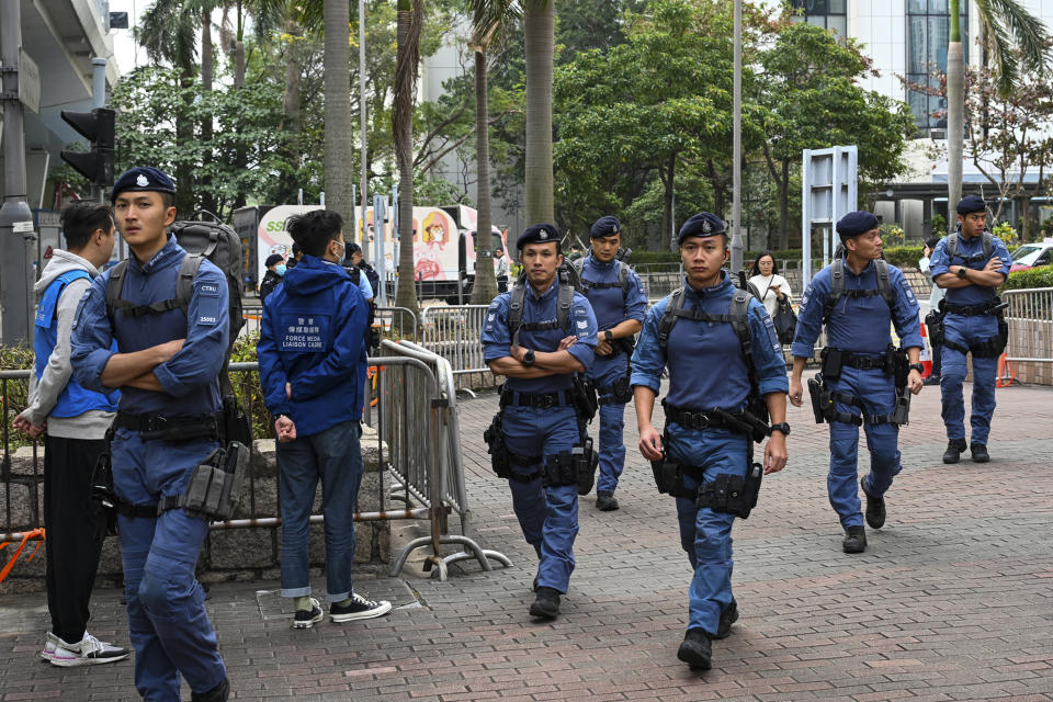 Police officers patrol outside the West Kowloon Magistrates' Courts, where activist publisher Jimmy Lai's trial takes place, in Hong Kong, Tuesday, Jan. 2, 2024. (AP Photo/Billy H.C. Kwok)