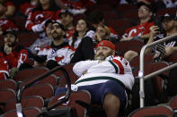 New Jersey Devils fans watch during the third period of Game 4 of an NHL hockey Stanley Cup second-round playoff series against the Carolina Hurricanes on Tuesday, May 9, 2023, in Newark, N.J. The Hurricanes won 6-1. (AP Photo/Adam Hunger)