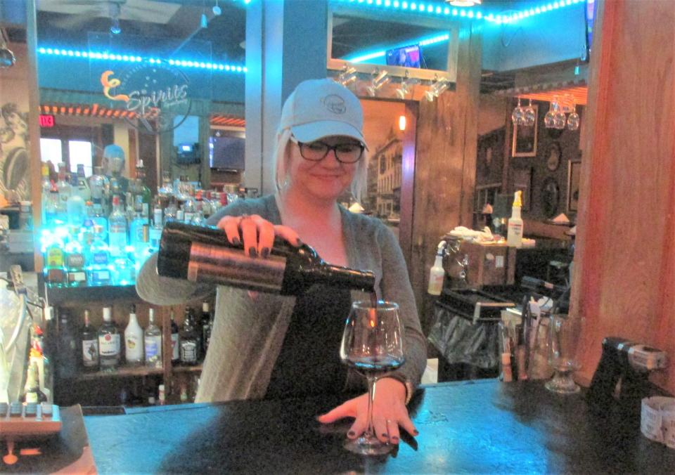 Hotel Millersburg bar manager Heidi Soto pours a glass of wine for a customer. The newly remodeled restaurant at the Hotel Millersburg is offering a Valentine's special this Friday and Saturday, which includes dinner for two, a bottle of wine and dessert.