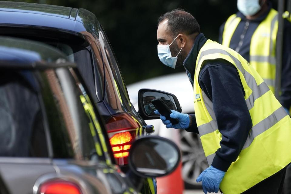 Serco staff working on behalf of NHS Test and Trace operate a coronavirus testing centre in July in Stone, England: Getty Images