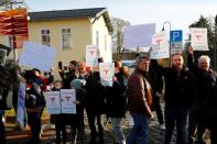 Demonstrators hold pro-Tesla posters during an action to support plans by U.S. electric vehicle pioneer Tesla to build its first European factory and design center in Gruenheide near Berlin