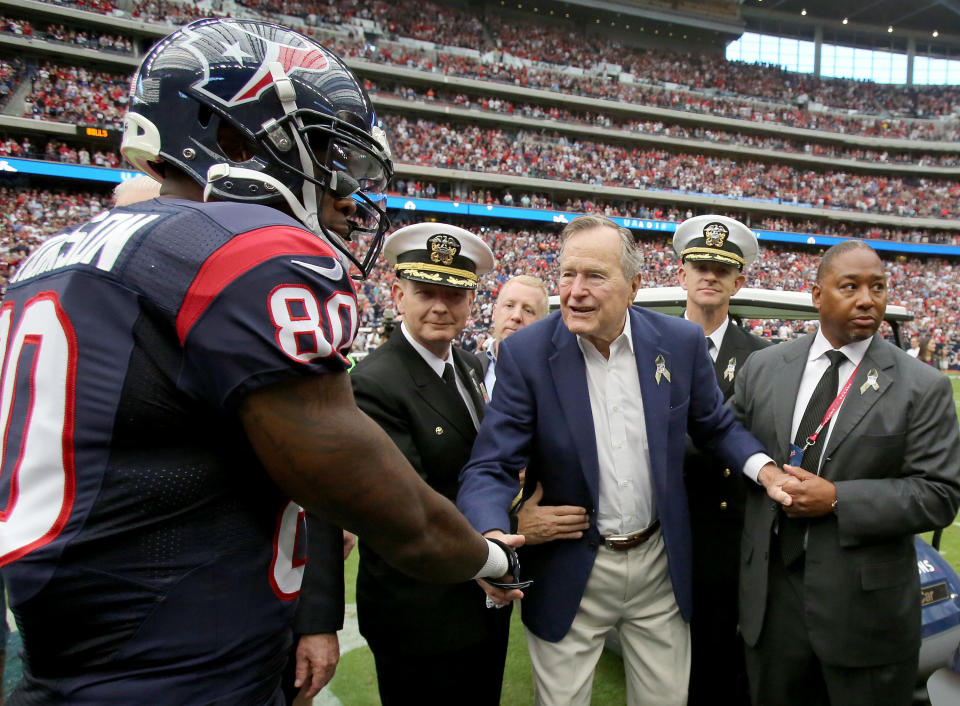 HOUSTON, TX- NOVEMBER 04: Former U.S. President George H. W. Bush shakes hands with Houston Texans wide receiver Andre Johnson #80 before the Houston Texans played against the Buffalo Bills on November 4, 2012 at Reliant Stadium in Houston, Texas. Texans won 21 to 9.(Photo by Thomas B. Shea/Getty Images)