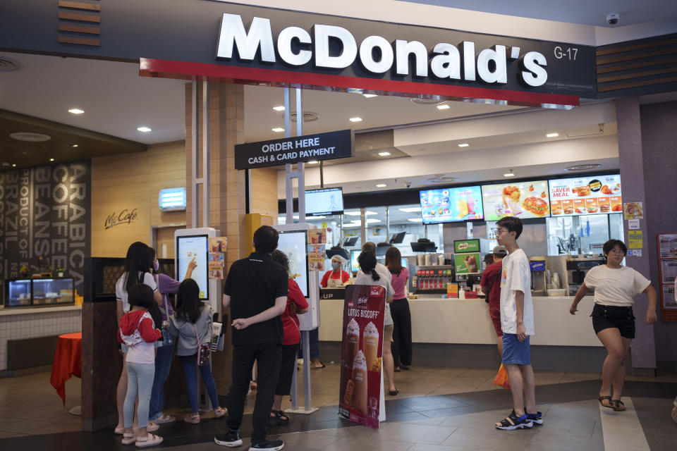 Customers place orders at a McDonald's restaurant at a shopping mall in Kuala Lumpur, Malaysia, Sunday, April 28, 2024. McDonald's releases its first quarter earnings Tuesday, April 30, 2024. (AP Photo/Vincent Thian)