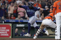 Seattle Mariners' Josh Rojas, left, is tagged out by Houston Astros catcher Yainer Diaz at the plate during the eighth inning of a baseball game Friday, May 3, 2024, in Houston. (AP Photo/Kevin M. Cox)