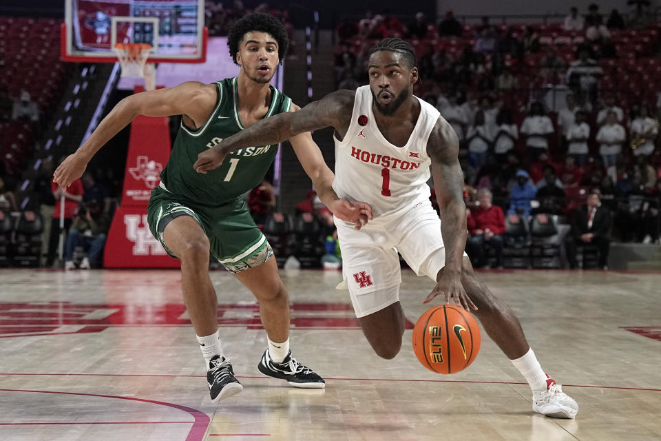 Houston's Jamal Shead, right, drives to the basket as Stetson's Tristan Gross defends during the second half of an NCAA college basketball game Monday, Nov. 13, 2023, in Houston. (AP Photo/David J. Phillip)