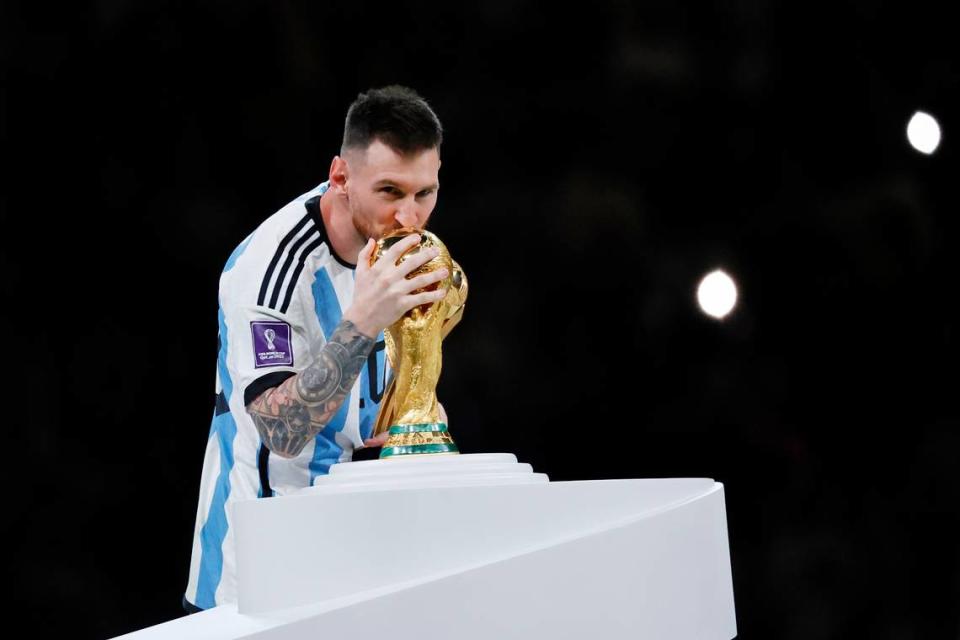 Dec 18, 2022; Lusail, Qatar; Argentina forward Lionel Messi (10) kisses the World Cup Trophy after winning the 2022 World Cup final against France at Lusail Stadium. Mandatory Credit: Yukihito Taguchi-USA TODAY Sports