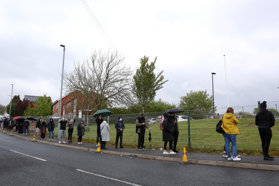 People are seen queueing to get vaccinated at Essa Academy on May 15, 2021 in Bolton, EnglandGetty Images