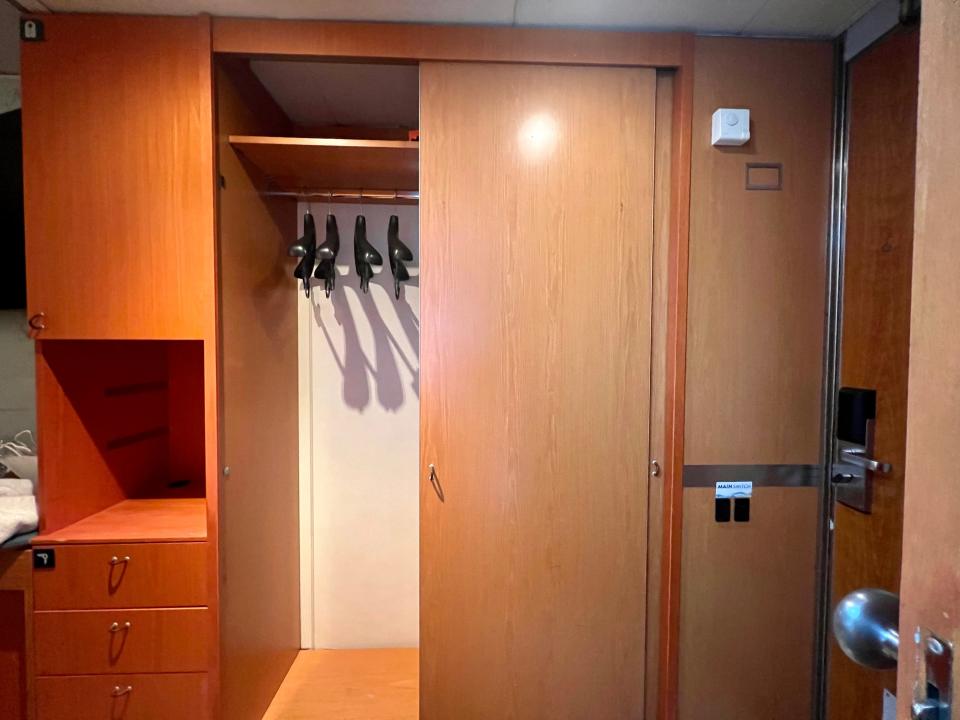 Margaritaville at Sea interior stateroom with closet door open and three black hangers inside