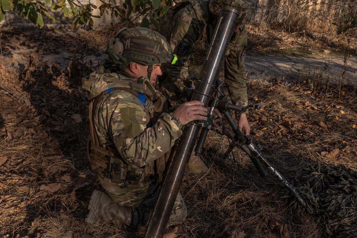 Ukrainian servicemen prepare to fire a mortar over the Dnipro River toward Russian positions on 6 November (AFP via Getty Images)