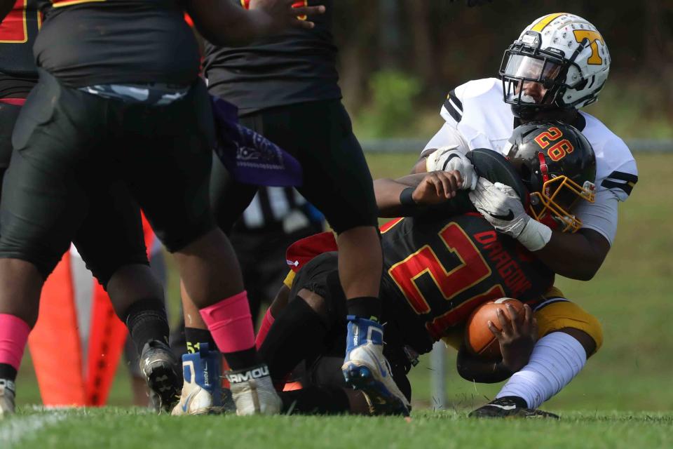 Tatnall defensive lineman Justin Smith (50) tackles Glasgow running back Zahbir Goggins (26) in the end zone for a safety.