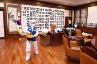 Employees from a disinfection service company sanitize the National Assembly in Seoul