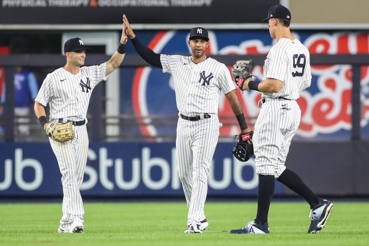 Andrew Benintendi (left) - acquired in a trade last Wednesday - celebrates a win over his old team, the Royals, with teammates Aaron Hicks and Aaron Judge.