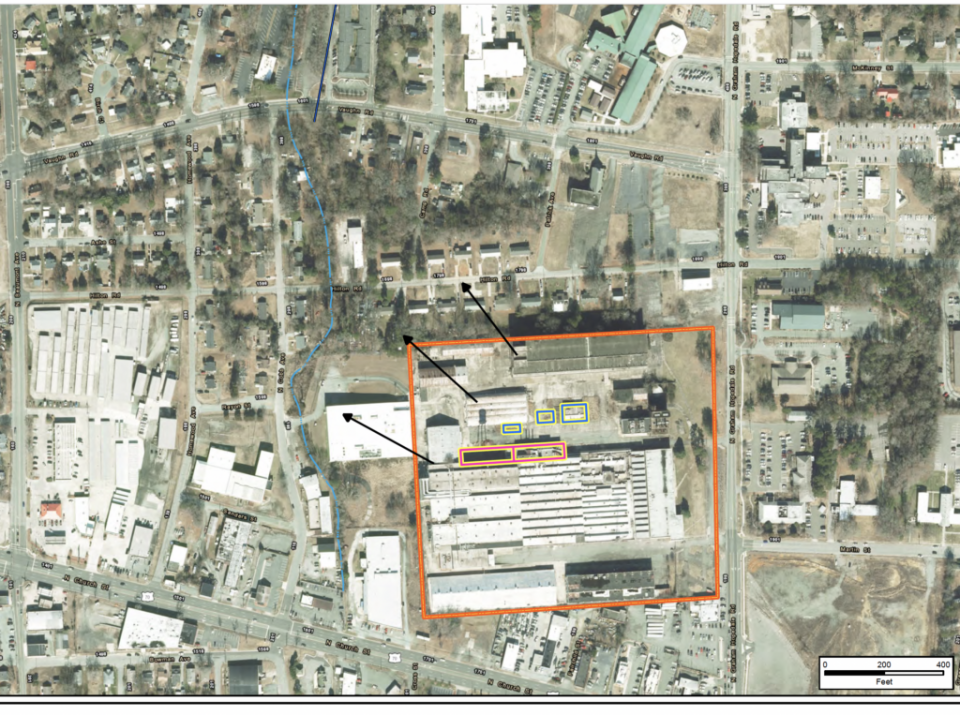 An aerial view of the Tarheel Army Missile Plant shows areas of PFAS contamination: Buildings 11 and 20, the former plating area, outlined in pink; and Buildings 23, 29 and 30, the former wastewater treatment plant