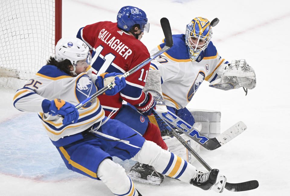 Montreal Canadiens' Brendan Gallagher (11) moves in on Buffalo Sabres goaltender Devon Levi as Sabres' Owen Power (25) defends during the third period of an NHL hockey game Thursday, Jan. 4, 2024, in Montreal. (Graham Hughes/The Canadian Press via AP)