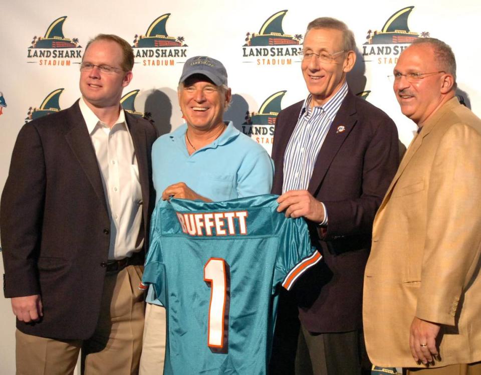 Jimmy Buffett, second from the left, poses with Jeff Ireland, general manager of the Dolphins, Stephen M. Ross, owner and managing general partner of the Miami Dolphins, and Tony Sparano, head coach, after his mimi-concert which announced the official changing of the name of Dolphin Stadium to LandShark Sadium, Friday, May 8, at the stadium.